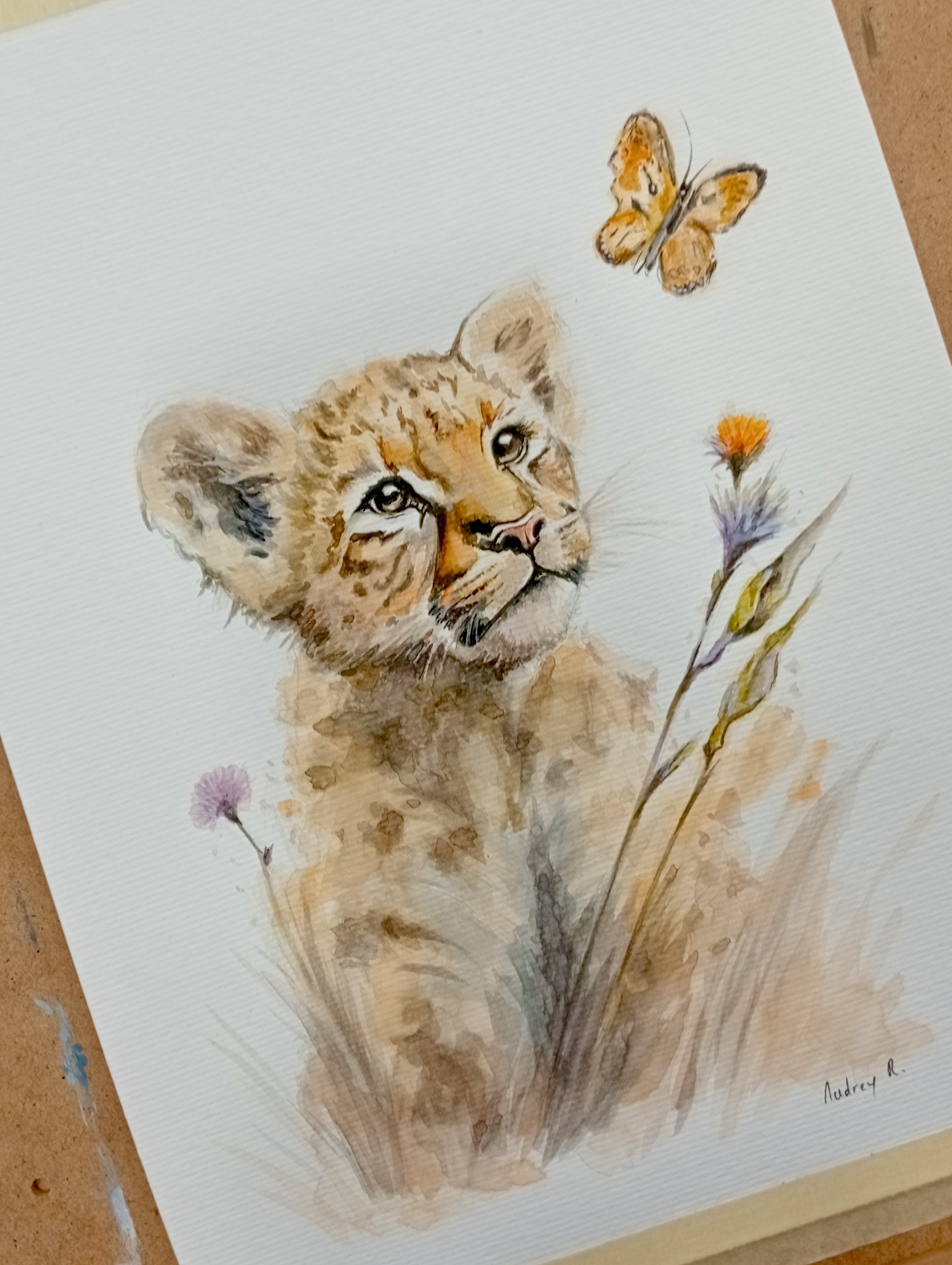 Acuarela de cachorro de león con mariposa